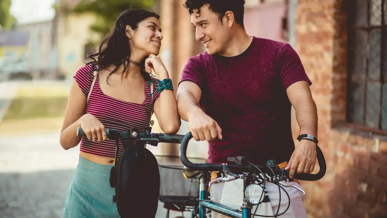 A smiling couple with bikes.