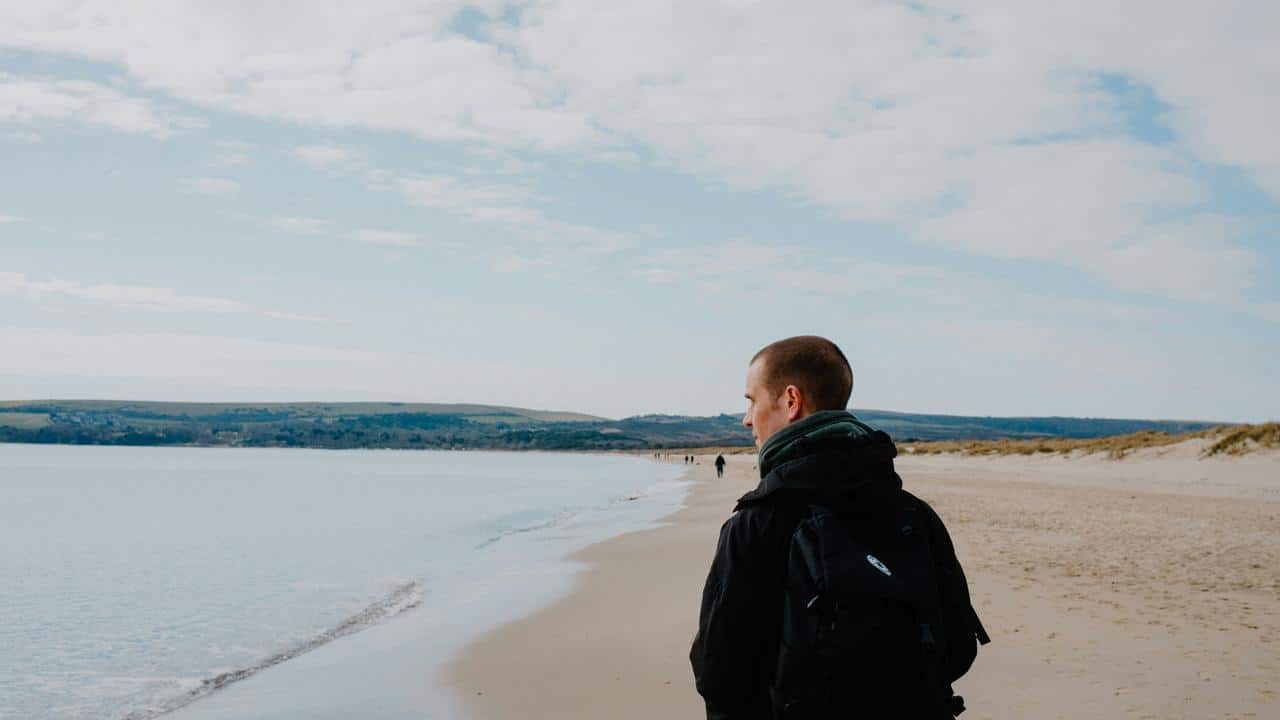 A person walking on a beach.
