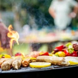 A barbecue with sausages and vegetables.