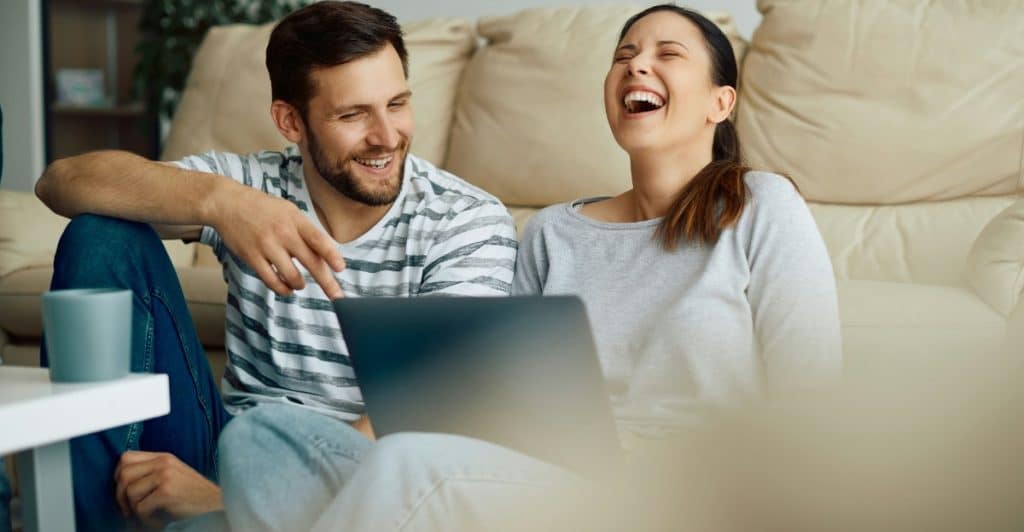 A married couple laughing
