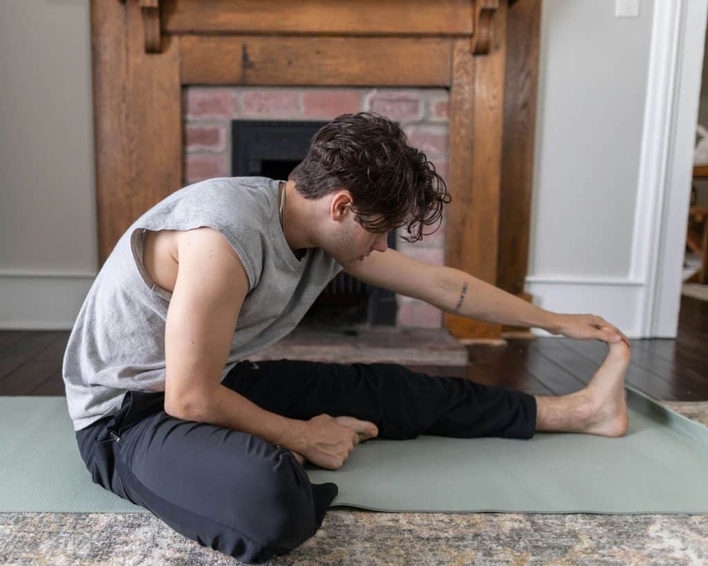 A man stretching at home