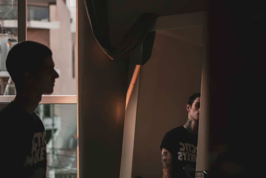 A man checking progress at the mirror