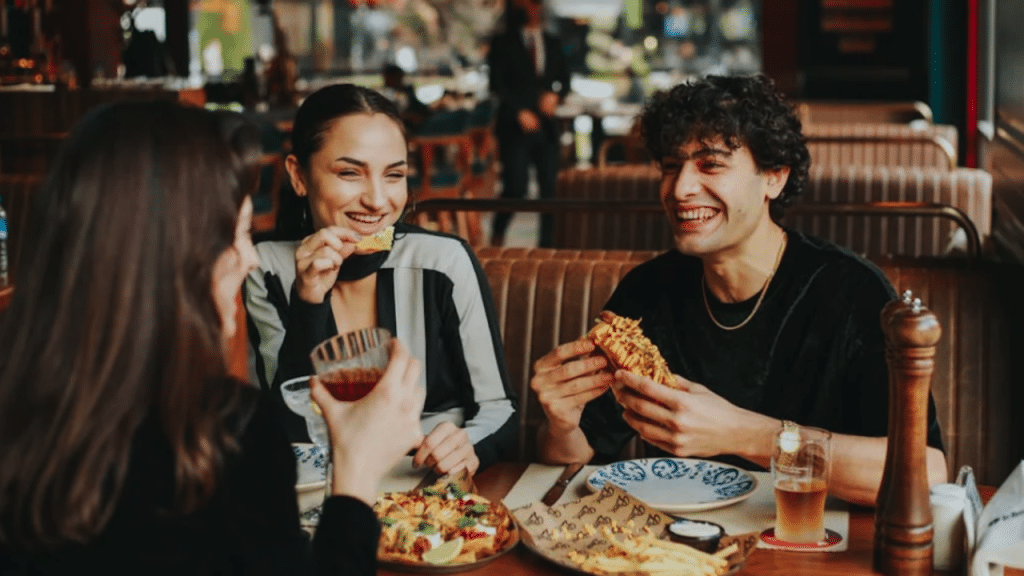 A man having pizza with female friends.
