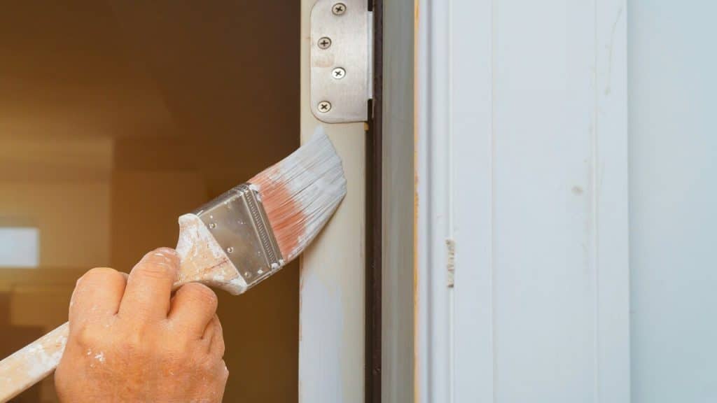 A man painting a door
