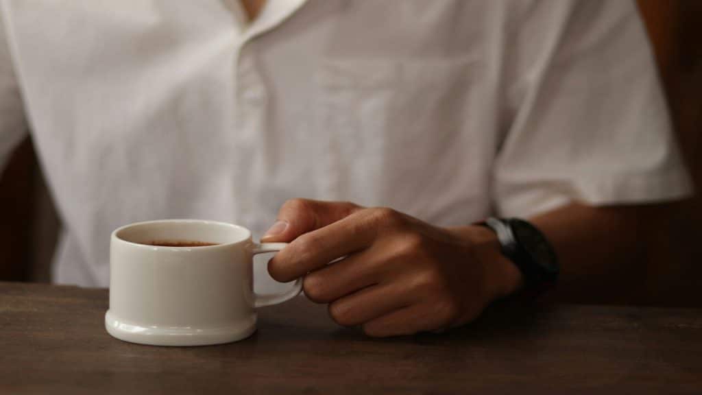A man holding a cup of coffee