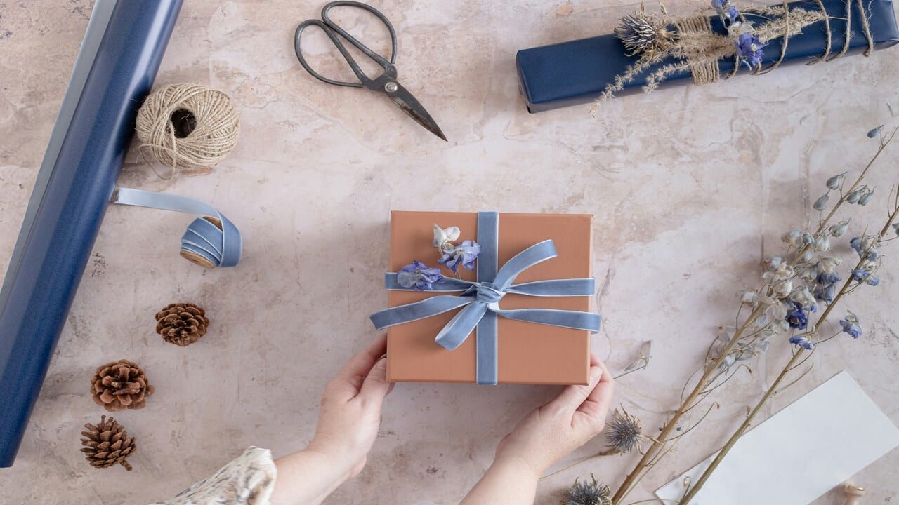 A woman preparing a gift.