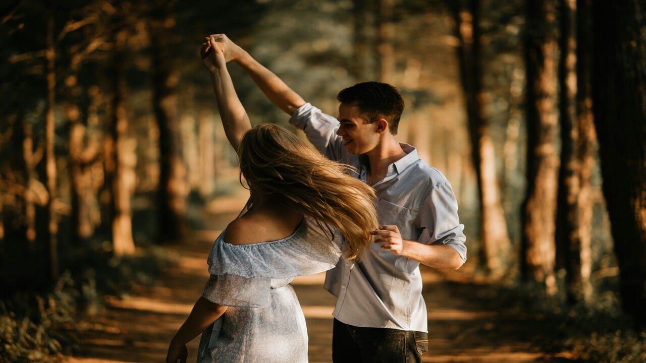 A couple dancing in the woods.