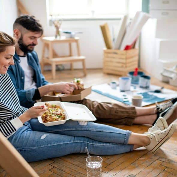 A couple having lunch on the floor.