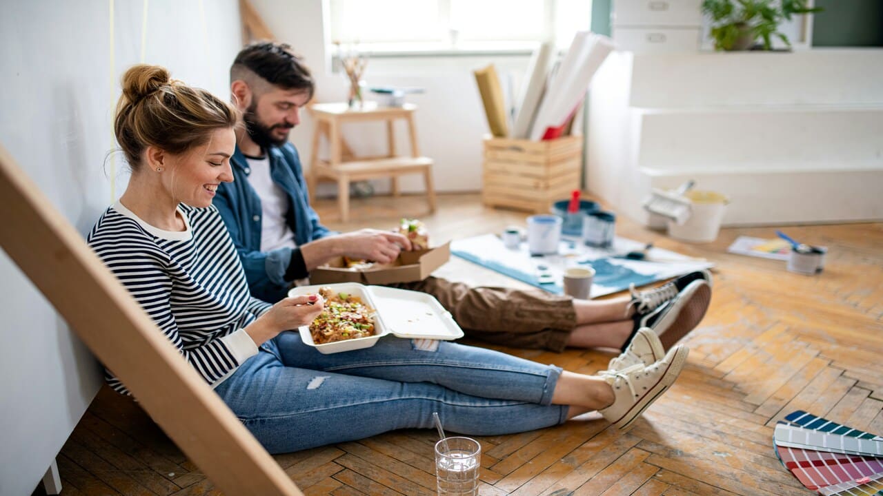 A couple having lunch on the floor.