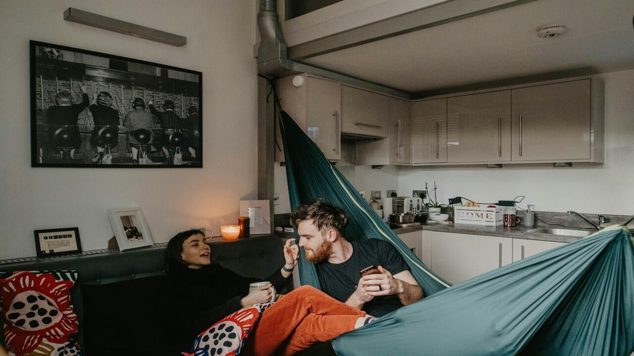 A couple with a hammock at home.