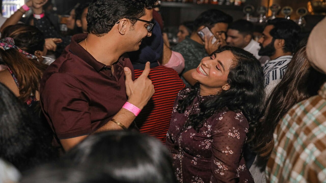 A couple saying hi to each other at a party.
