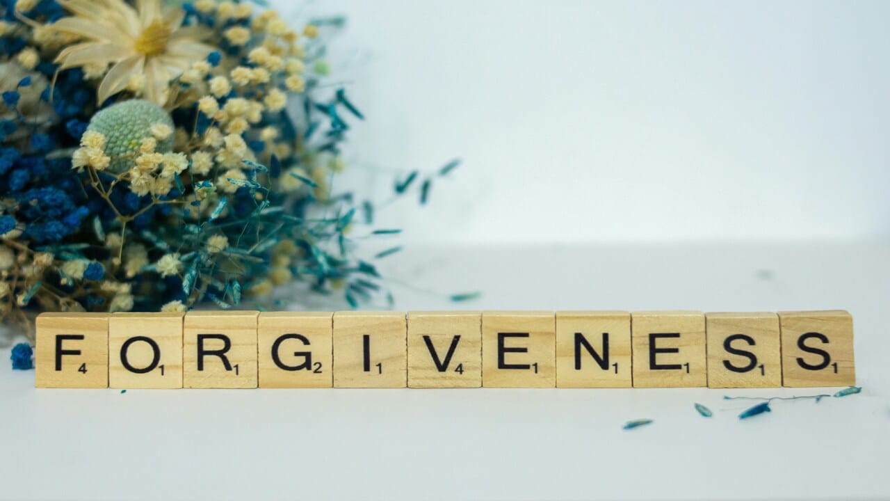 The word “forgiveness” spelled out in wooden letters.