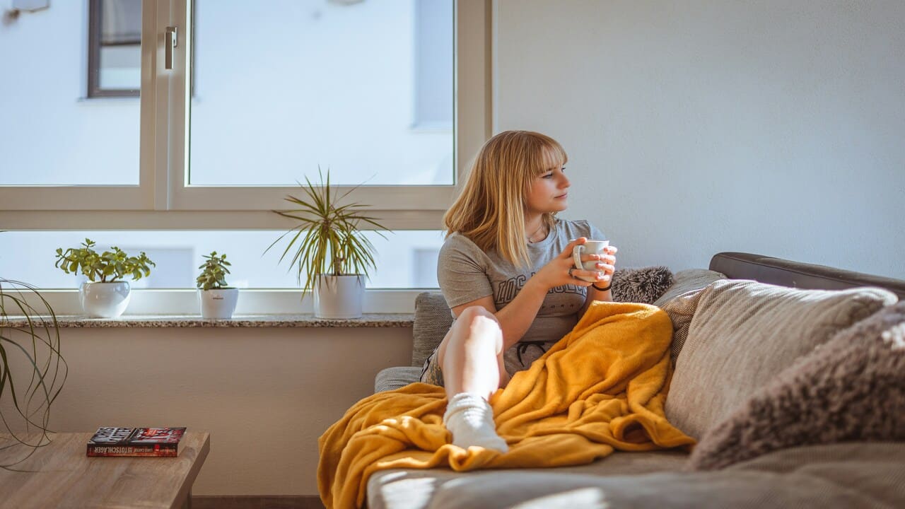 A woman looking sad at home.
