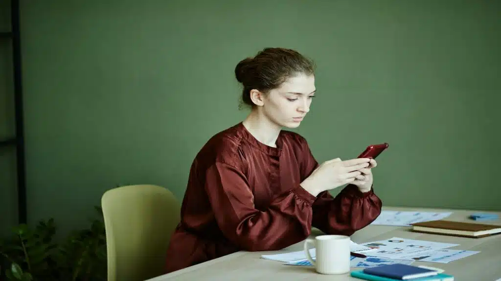 A woman waiting for a text