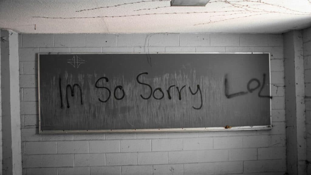 “I’m so sorry lol” written on a board