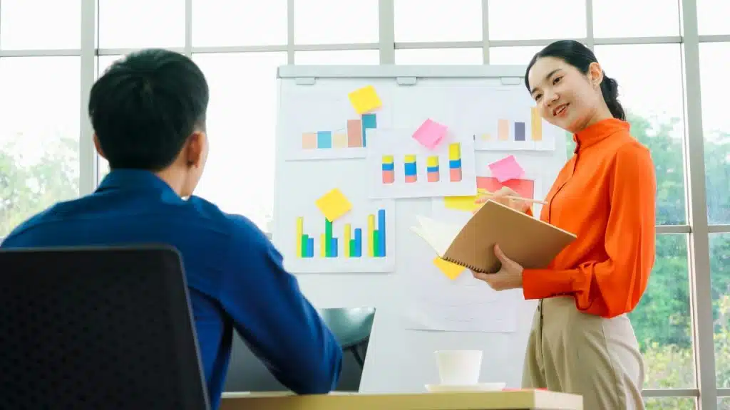 A woman presenting data to a colleague