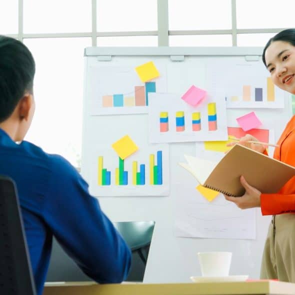 A woman presenting data to a colleague