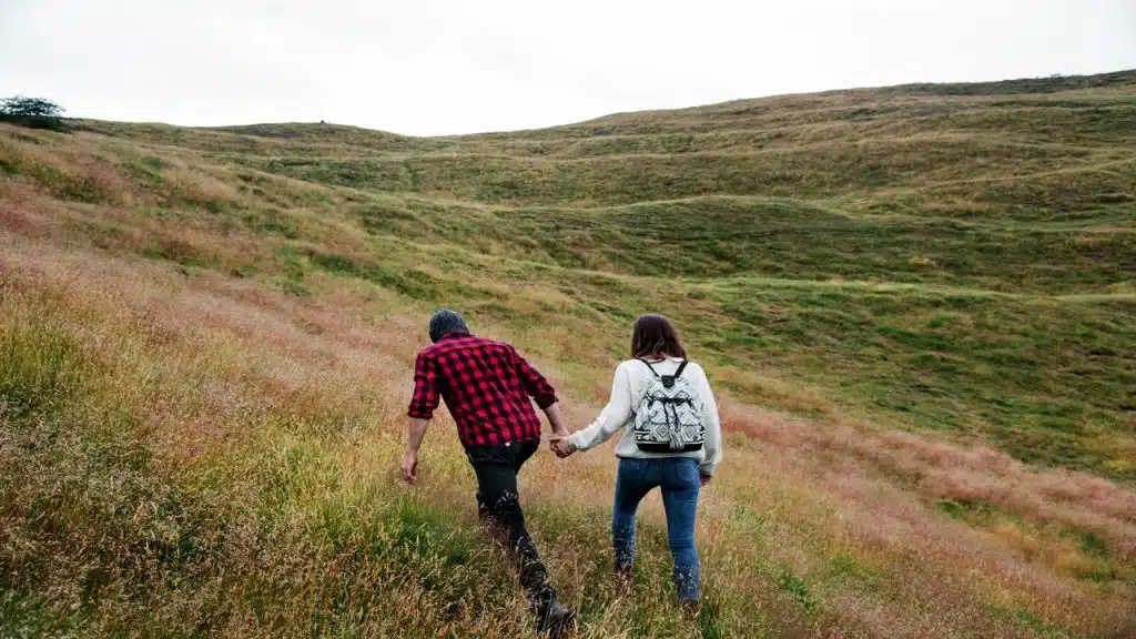 A couple hiking while holding hands