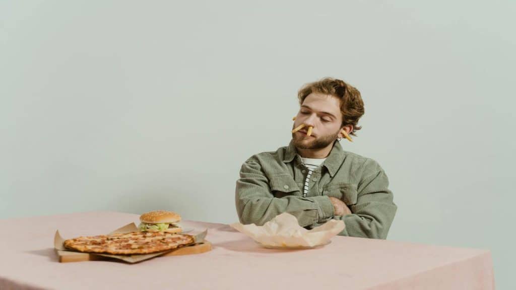 A man playing with his food.