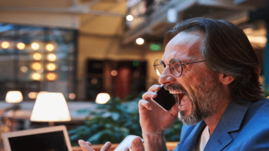 An angry man yelling at the phone