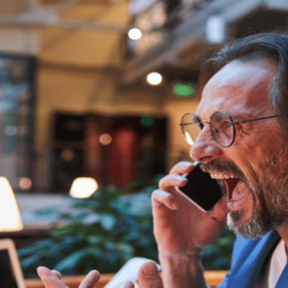 An angry man yelling at the phone