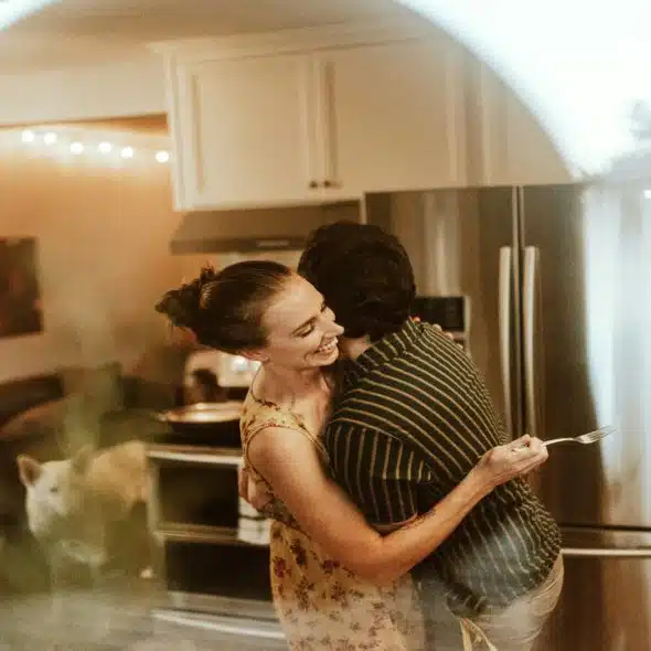 A couple hugging in the kitchen