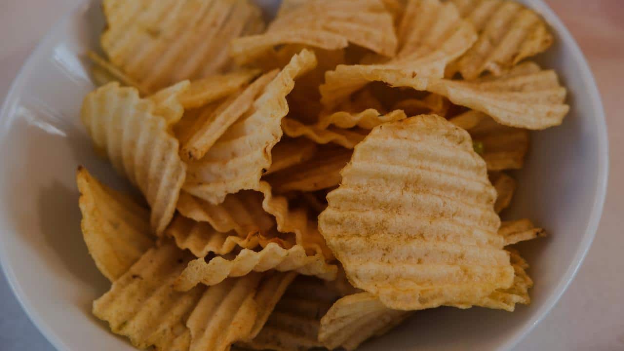 A bowl of ridged potato chips.