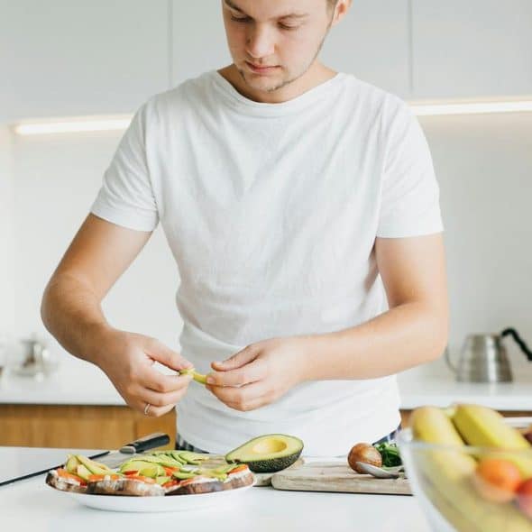 A man preparing food in a kitchen.