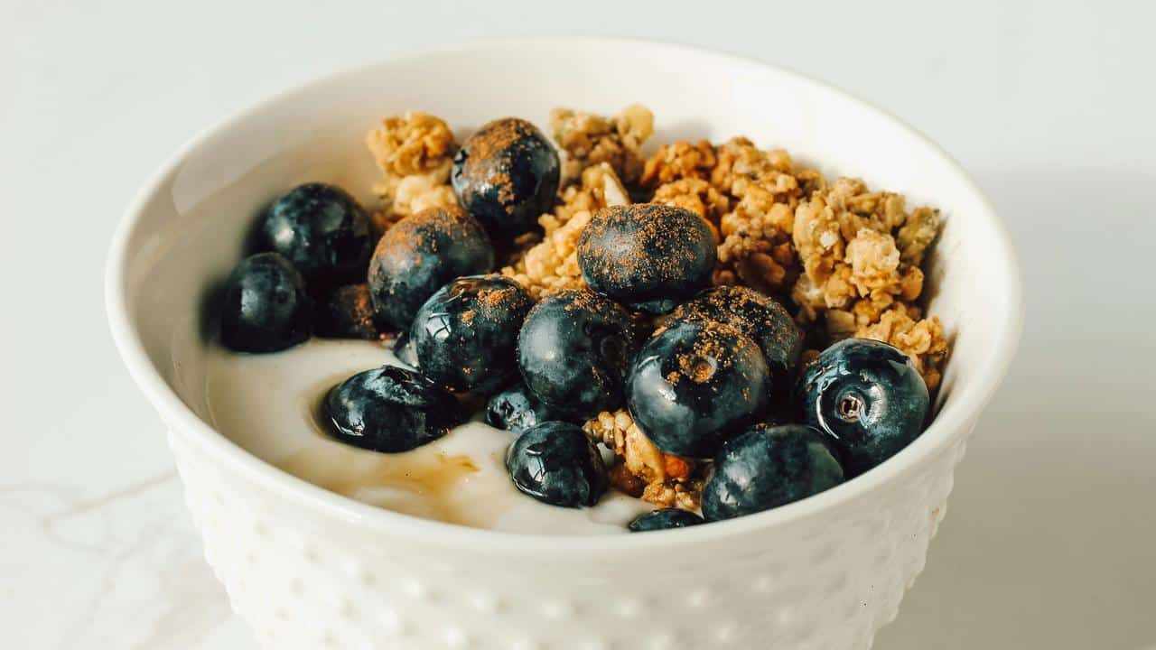 A yogurt bowl with blueberries and granola.