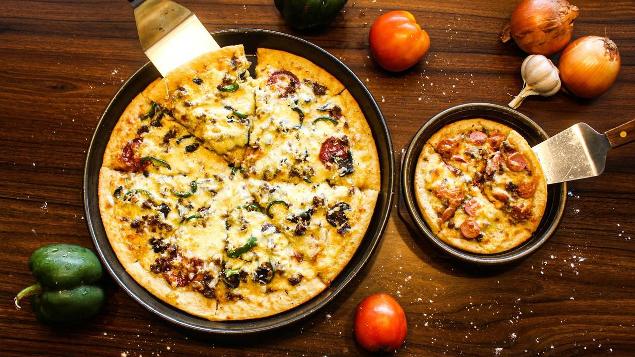 A large and small frittata on a table.