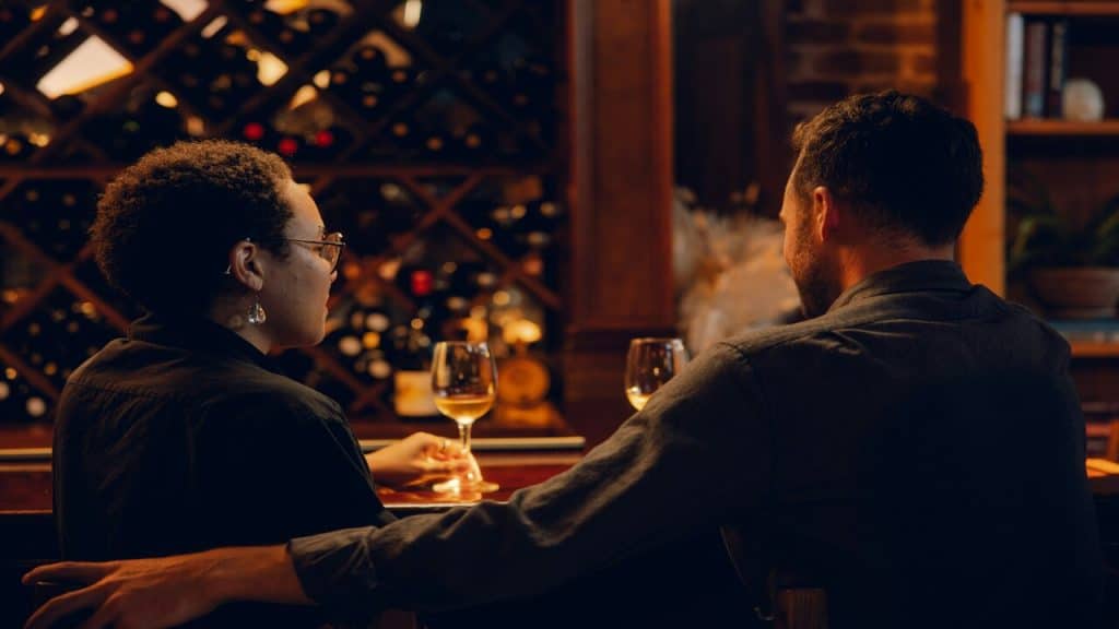 A couple talking at a bar
