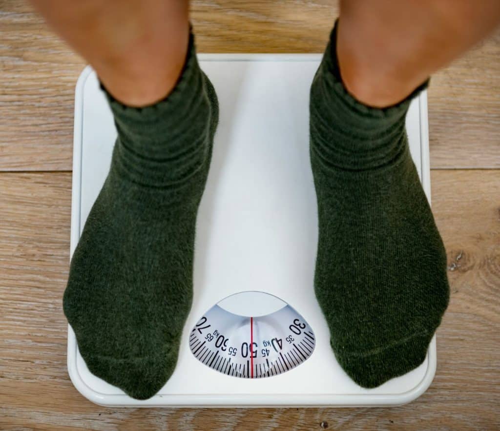 A person standing on a weighing scale