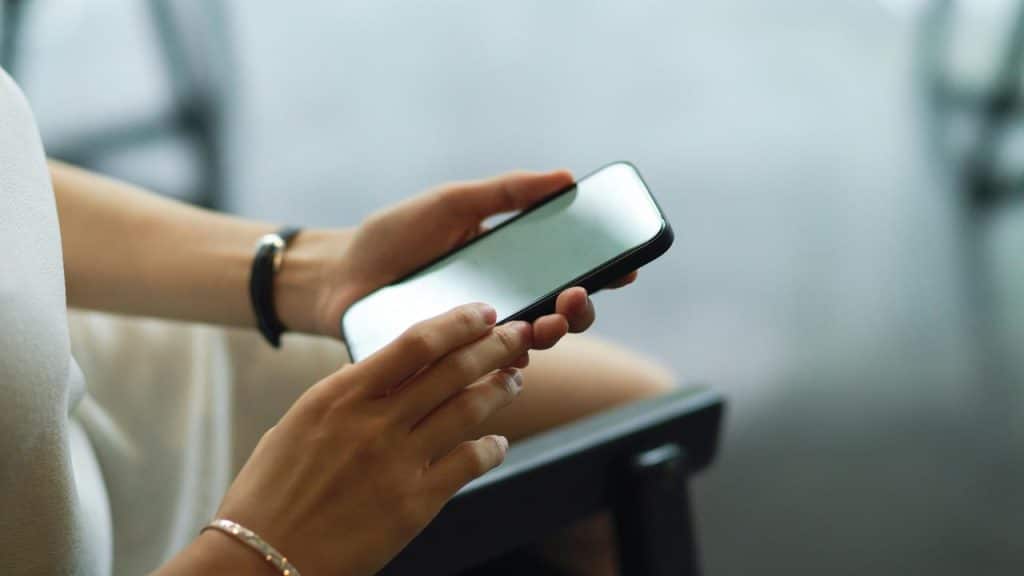 A person holding and using a smartphone.