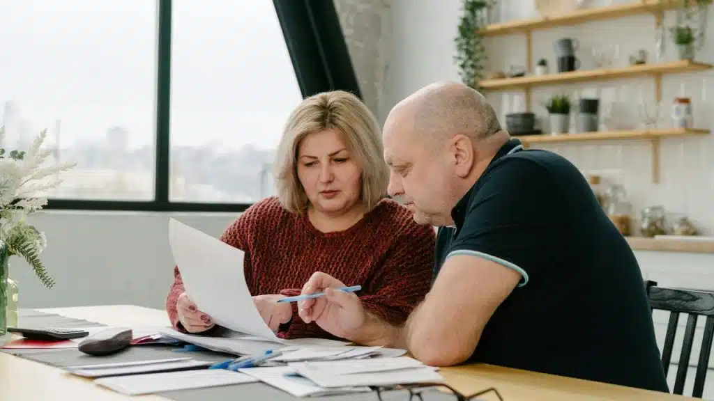 A couple reviewing documents at a table.