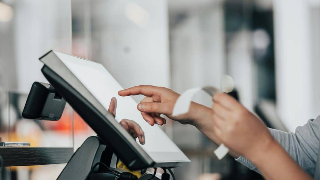 A person using a touchscreen checkout.