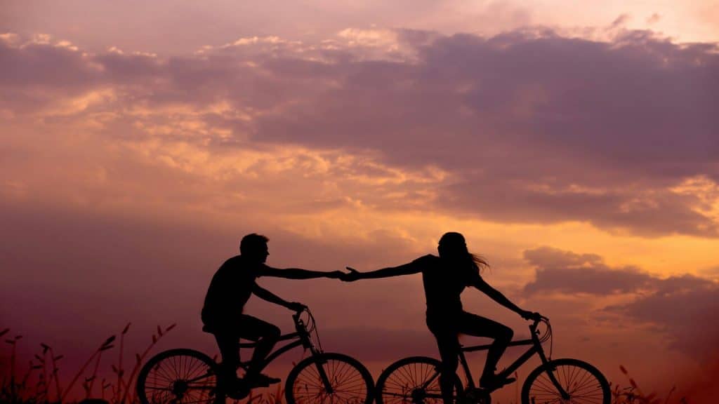 A couple biking at sunset