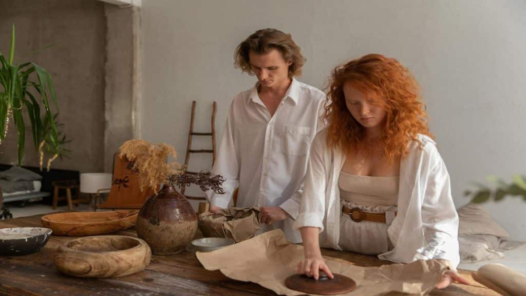 A couple wrapping ceramic bowls