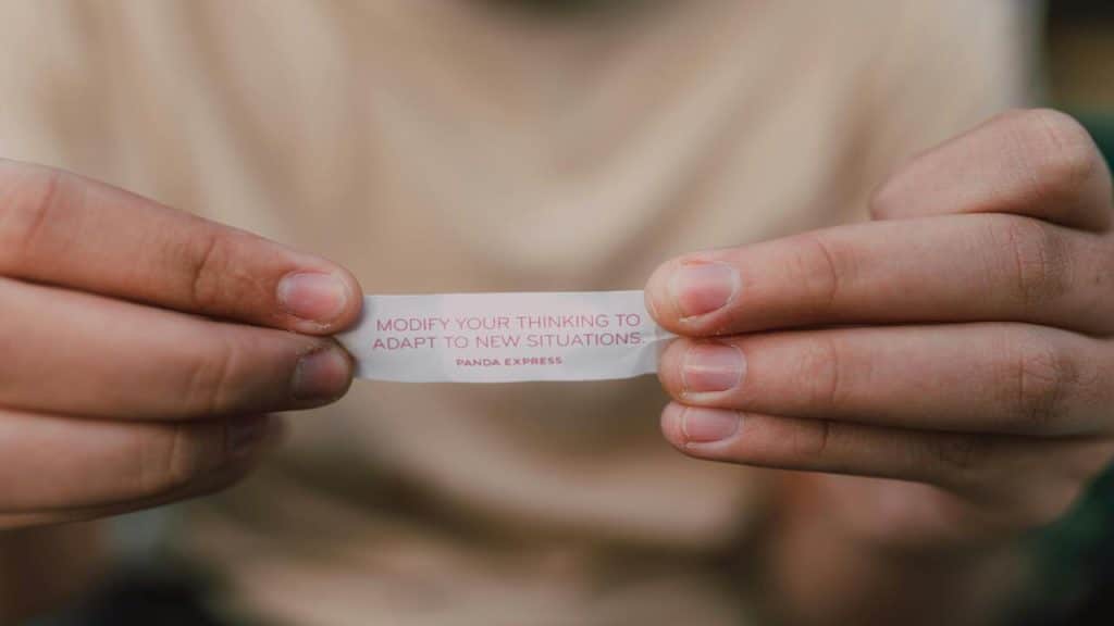 A person holding an inspirational quote.