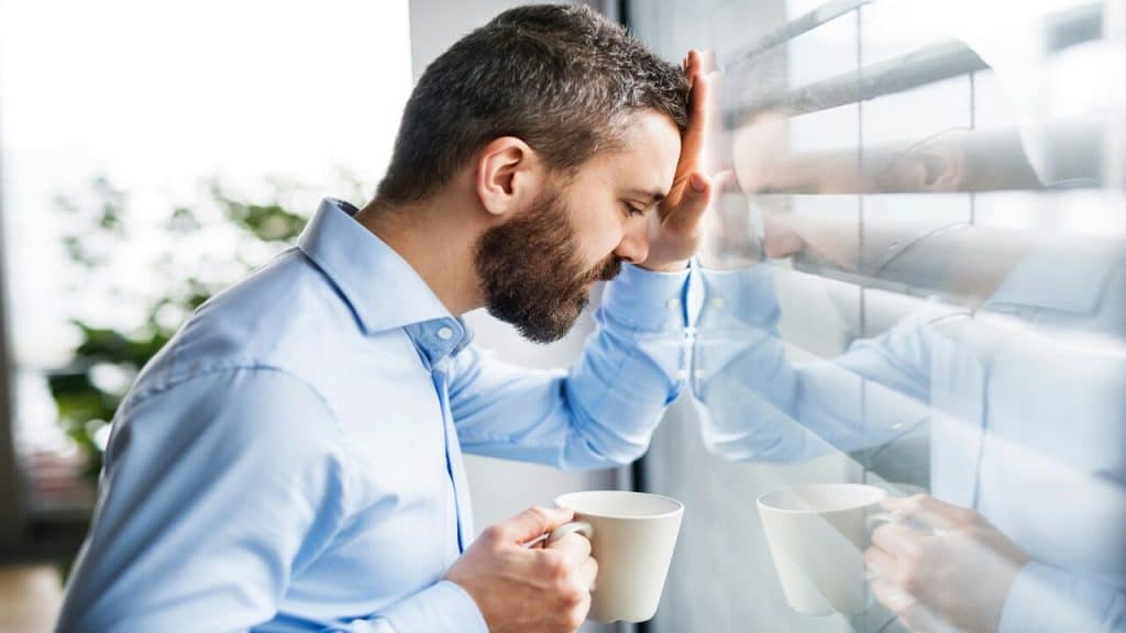 A man looking sad by the window