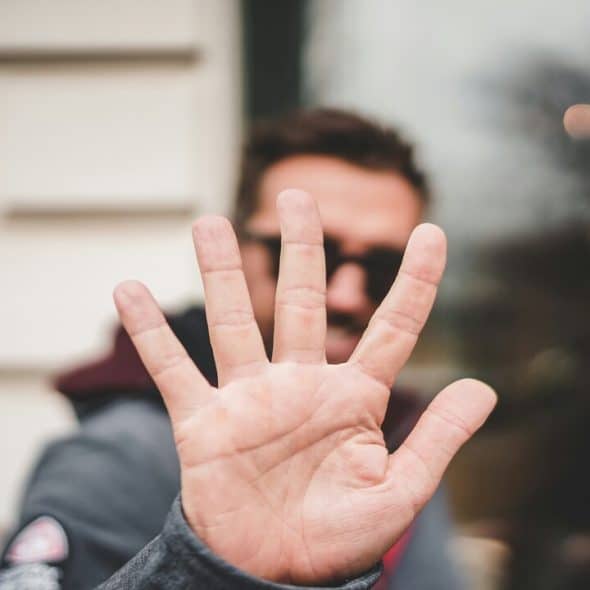 A man saying “no” with his hand