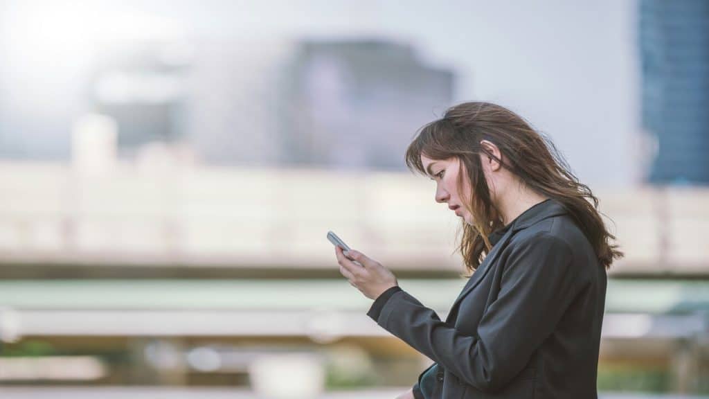 A woman waiting for a text