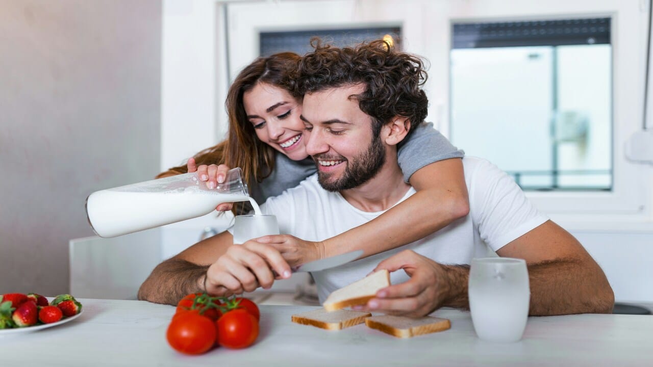 A couple having lunch in the kitchen.
