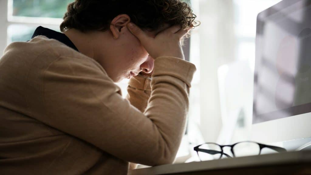 A stressed businessman at work.