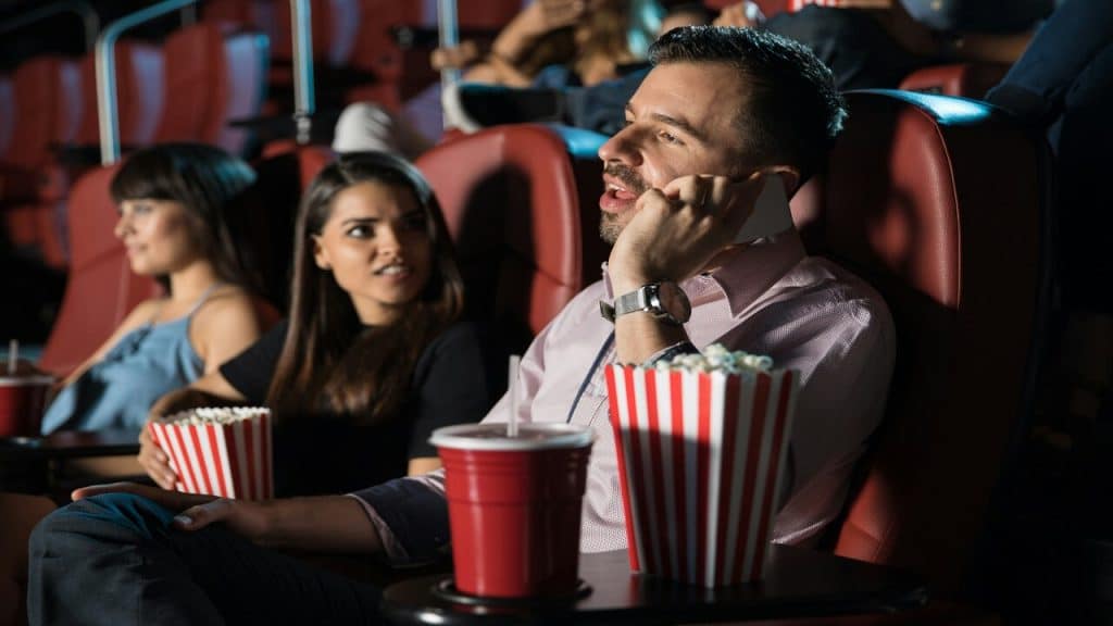 A man talking while in the cinema