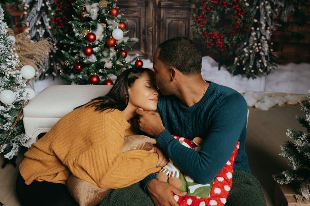 A man kissing a woman’s forehead