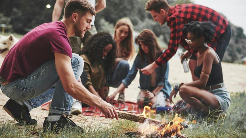 A group of friends sitting around a campfire.