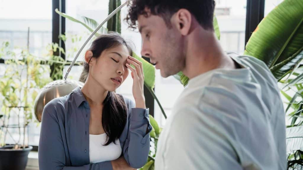 A woman appearing fed up with her partner. 