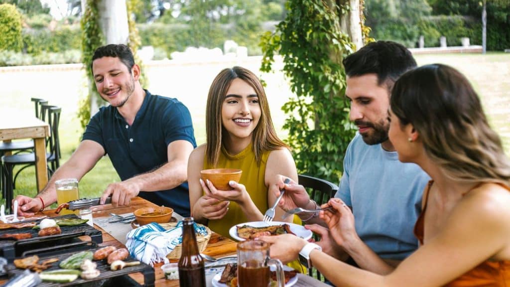 A group of friends enjoying a meal outdoors.