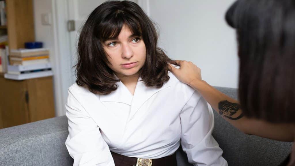 A sad woman being comforted by her friend