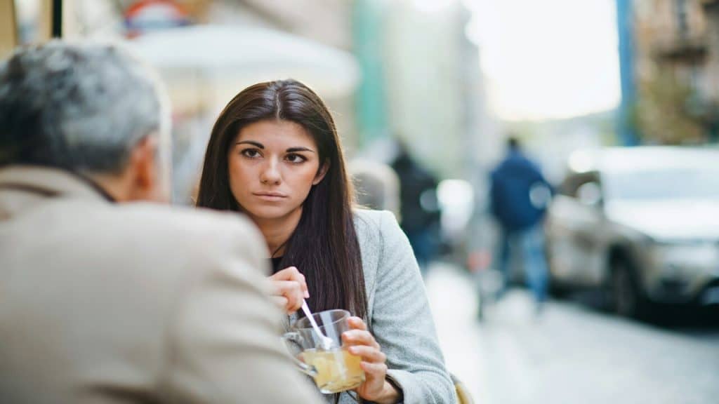 A woman listening to a man talking.